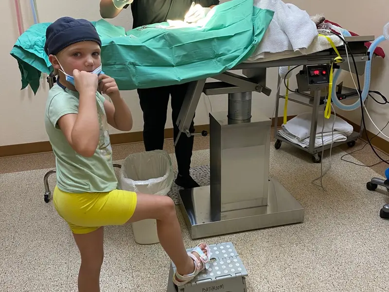 A young visitor playing surgeon at the training table.