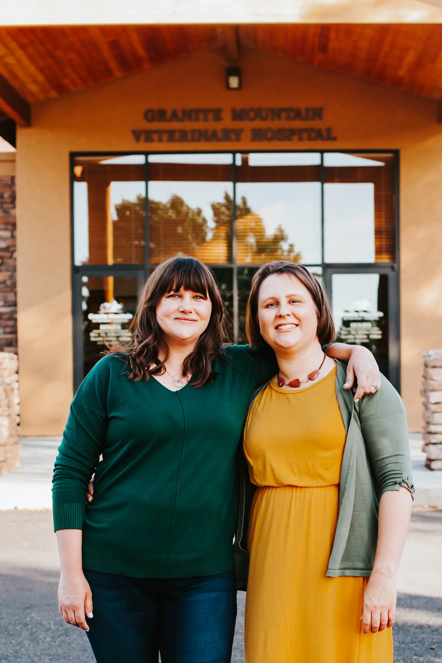 Dr. Sarah Bason and Dr. Katherine Siens together outside the Granite Mountain Veterinary Hospital entrance.