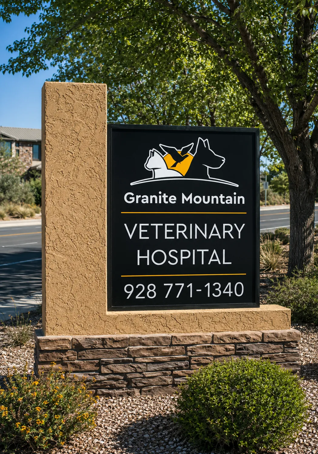 The Granite Mountain Veterinary Hospital sign mounted on the building exterior, showing the cat-and-dog logo and the phone number 928-771-1340.