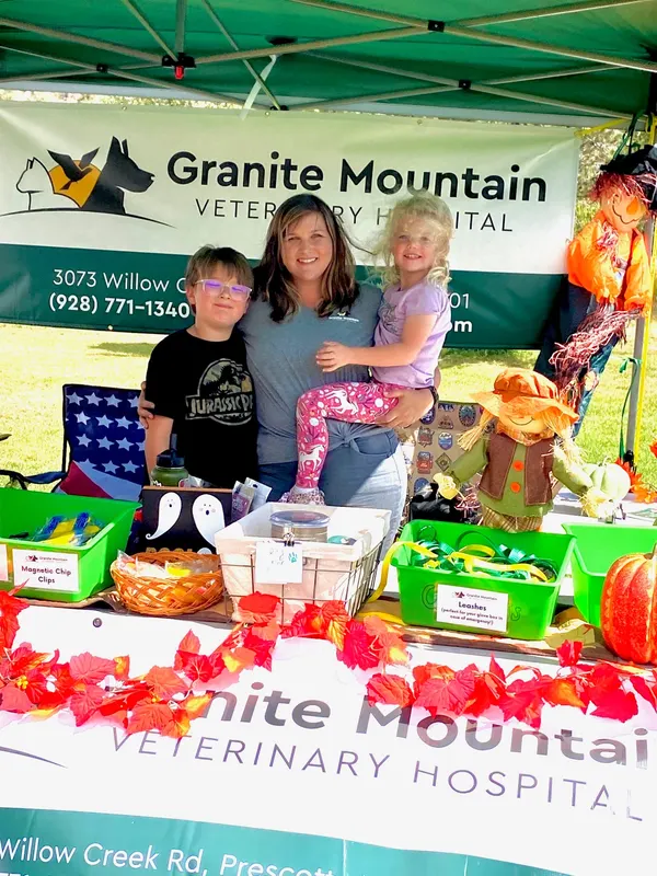 The team at a community event booth with the Granite Mountain Veterinary Hospital banner.